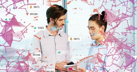 Business partners reviewing analytics on devices with network overlay and notifications