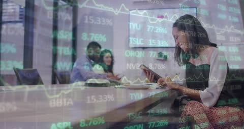 Businesswoman Analyzing Financial Data and Graphs