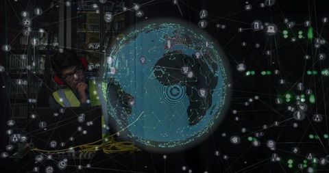 Network technician monitoring holographic globe in dim data center with hi-vis vest