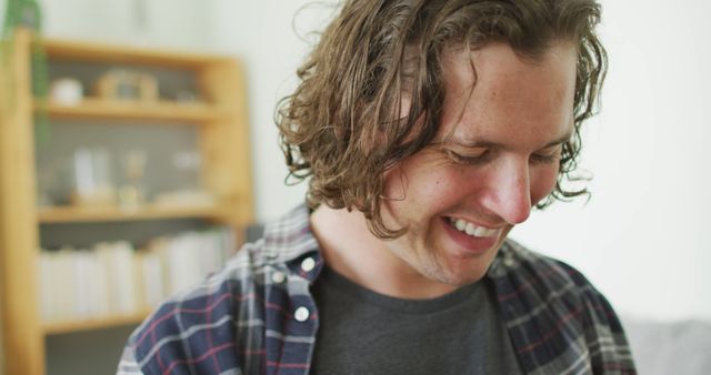 Smiling Man with Curly Hair in Casual Setting - Download Free Stock Images Pikwizard.com