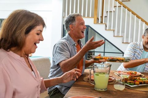Senior Friends Enjoying Meal Together at Home