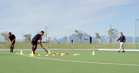 Hockey Players Training on Artificial Turf Field