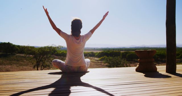 Woman Practicing Morning Yoga Outdoors with Arms Raised in Meditation - Download Free Stock Images Pikwizard.com