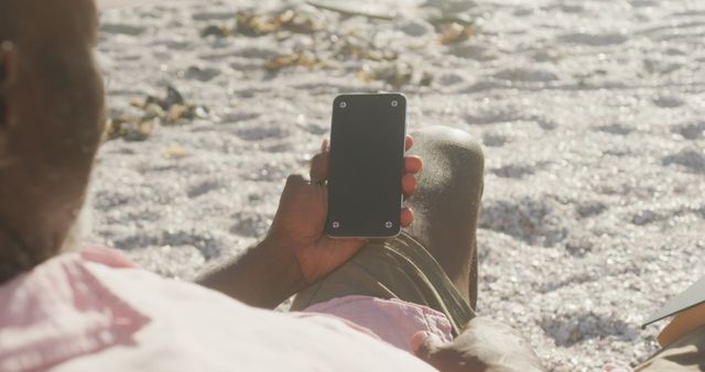 Man Relaxing on Beach Holding Smartphone with Blank Screen - Download Free Stock Images Pikwizard.com