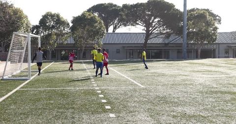 Amateur Soccer Players Competing on Sunny Field