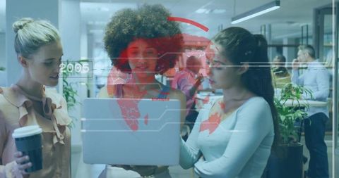 Three Businesswomen Discussing Data on Laptop in Modern Office