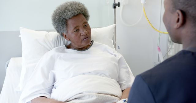 African American Elderly Patient Speaking with Male Nurse in Hospital Bed - Download Free Stock Images Pikwizard.com