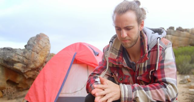 Young Man Contemplating Next to Tent in Outdoor Adventure - Download Free Stock Images Pikwizard.com