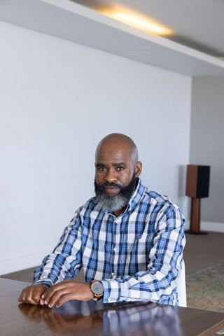 Mature Man Checking Watch during Downtime in Minimalist Interior