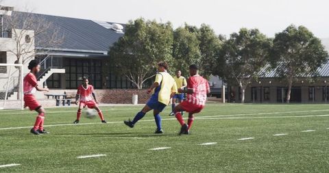 Young soccer players training on grass field