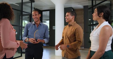 Diverse Team Celebrating Achievement and Collaboration in Office