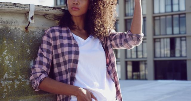 Confident Young Woman Posing on Urban Rooftop in Casual Clothing - Download Free Stock Images Pikwizard.com