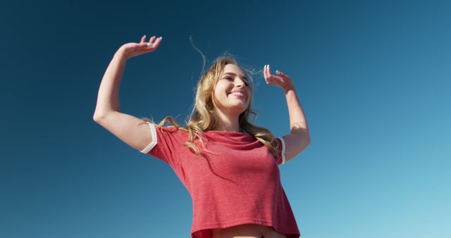 Happy woman enjoying sunny day with blue sky - Download Free Stock Images Pikwizard.com