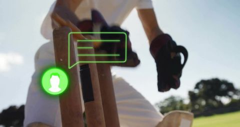 Backlit cricket batter standing at stumps holding bat with neon green chat overlay