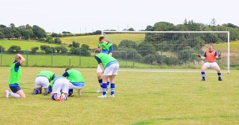 Youth soccer team practicing on rural field