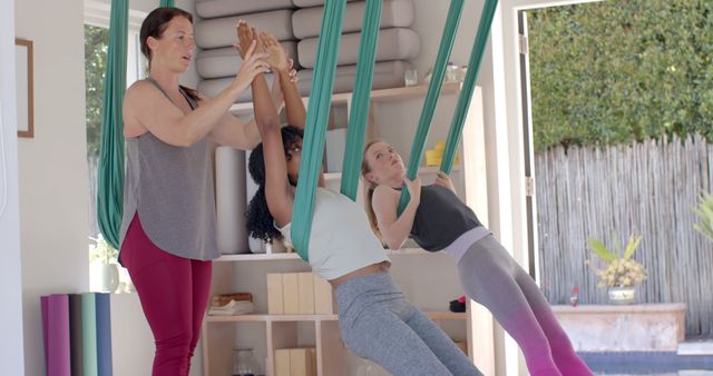 Women Practicing Aerial Yoga with Instructor in Well-Lit Studio - Download Free Stock Images Pikwizard.com