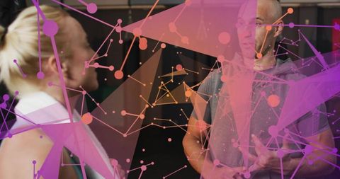 Coaching duo exchanging cues in gym with magenta network overlay and abstract triangles
