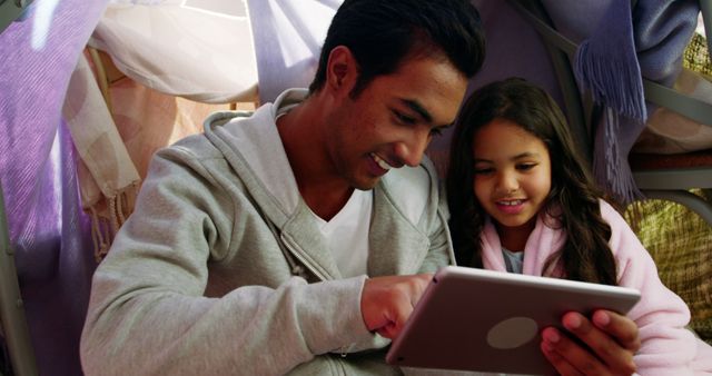 Smiling Father and Daughter Using Tablet Together at Home - Download Free Stock Images Pikwizard.com