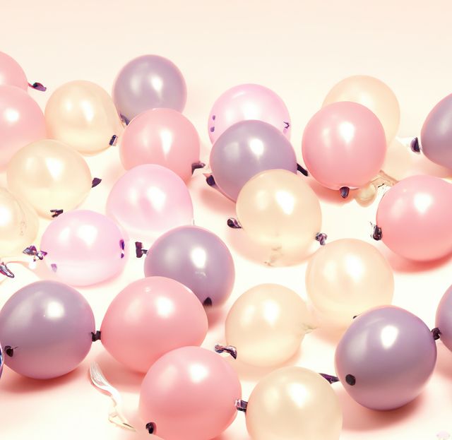 Close up of multiple purple and pink balloons on beige background. Christmas, tradition and celebration concept.