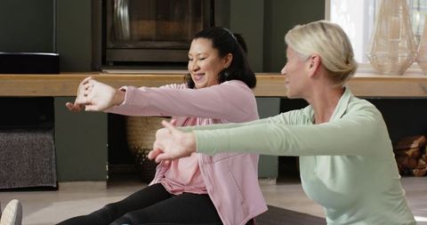 Senior Women Doing Stretching Exercises in Cozy Home Environment