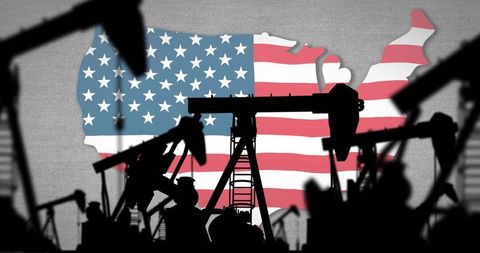 Oil pumpjacks casting silhouettes over u.s. Flag map representing american energy sector