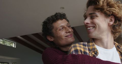 Happy Gay Couple Embracing at Home
