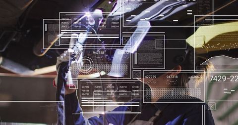 Female mechanic inspecting undercarriage using wrench with augmented reality HUD in garage