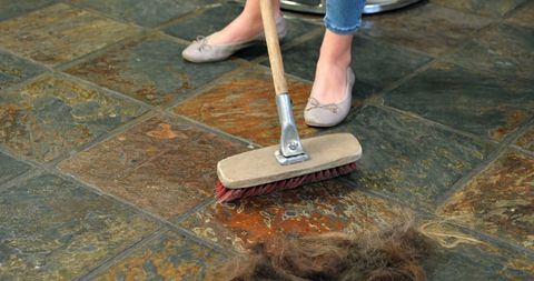 person clearing tiled floor of hair using broom for cleanliness - Download Free Stock Images Pikwizard.com