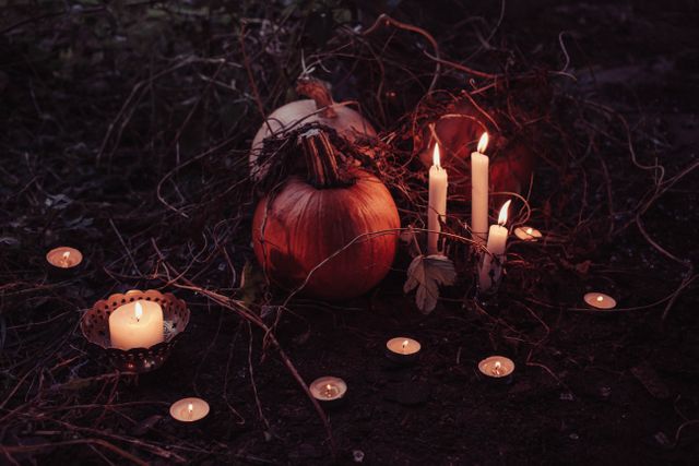 This image captures a spooky Halloween night scene featuring pumpkins illuminated by candlelight. Ideal for Halloween-themed projects, event promotions, creative writing prompts, and festive decorations.