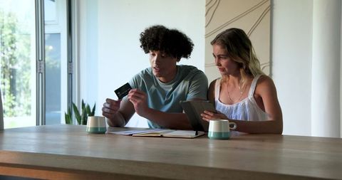 Couple discussing financial documents at home