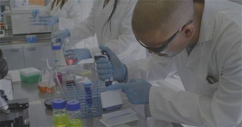 Scientists Conducting Laboratory Experiment with Precision Focus