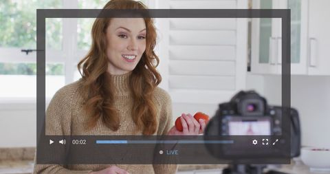Woman Recording Food Vlog in Kitchen Setting