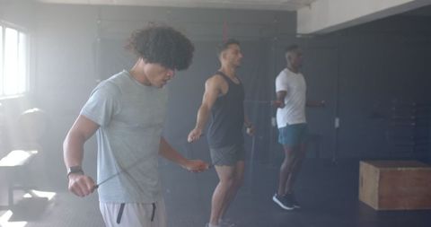 Men Jump Rope Workout in Gym Demonstrating Focus and Team Spirit