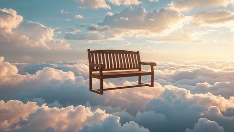 Floating wooden bench above clouds dreamscape
