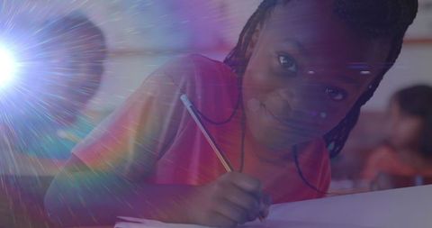 Young Schoolgirl Writing in Classroom with Magical Light Trails