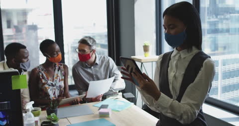 Diverse Business Team Collaborating with Face Masks in Modern Office