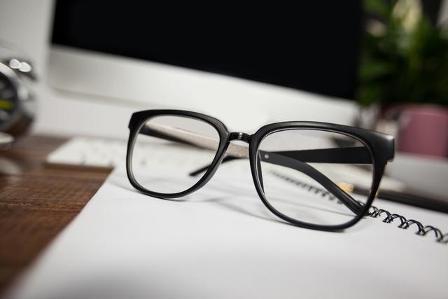 Close- up of reading glasses on office desk in the office