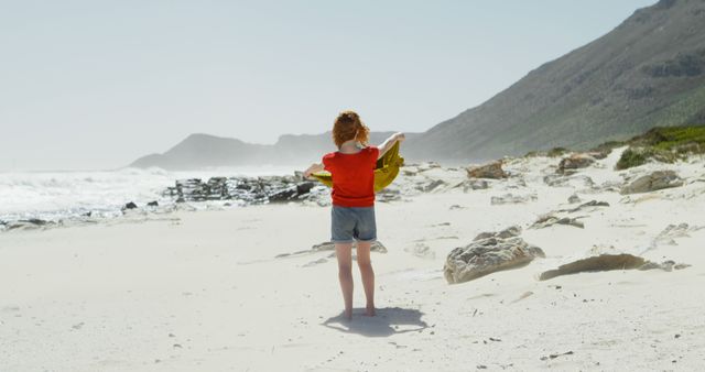 Child Playing on Rocky Beach with Towel, Enjoying Summer Day - Download Free Stock Images Pikwizard.com