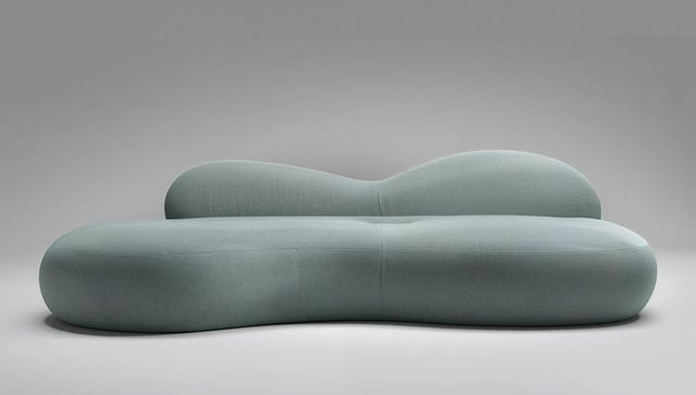 Sculptural rounded modern sofa in seafoam blue fabric for minimalist interior design