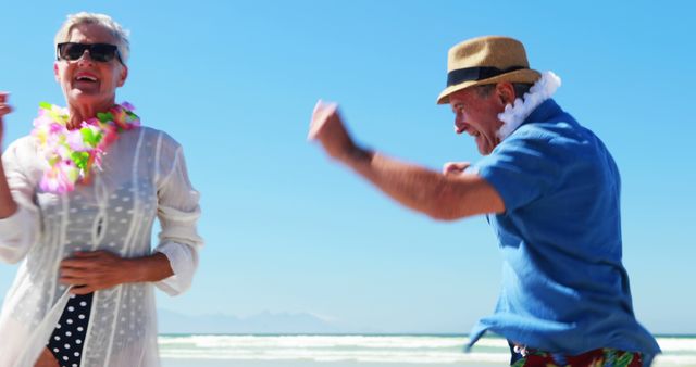 Senior couple enjoying dance together on sunny beach. Smiling and wearing colorful leis, they represent joy, relaxation, and active retirement. Perfect for travel brochures, retirement community promotions, summer vacation ads, and healthy lifestyle content.