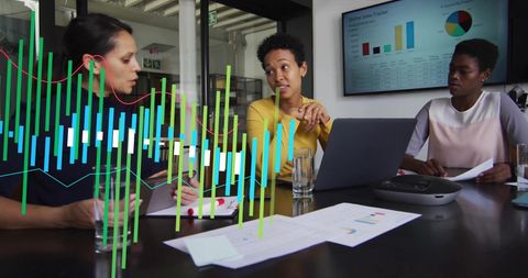 Diverse Female Team Analyzing Data in Modern Office Meeting