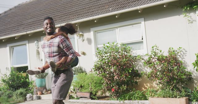 Father enjoying playful piggyback ride with daughter in yard - Download Free Stock Images Pikwizard.com