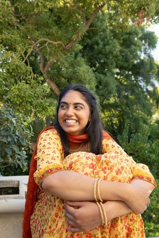 Young woman in traditional attire enjoying serene park