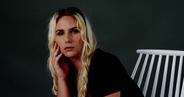 Woman with Blonde Hair Posing Against Dark Backdrop - Download Free Stock Images Pikwizard.com