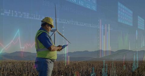 Engineer in Renewable Energy Field Monitoring Data on Tablet