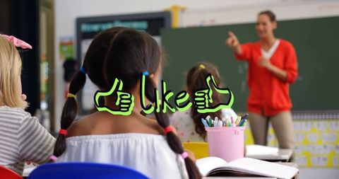 Sitting student with braids facing teacher in classroom with green like icon overlay