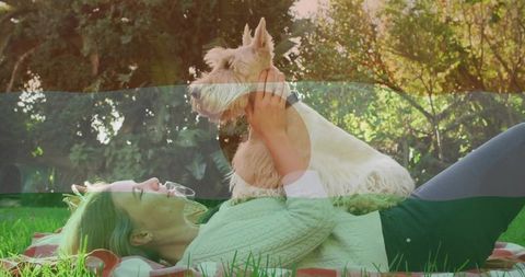 Woman Relaxing with Terrier on Picnic Blanket