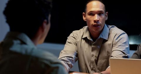 Business meeting at night: professionals discussing strategy and ideas