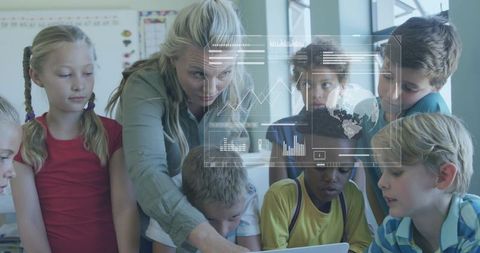 Teacher Guiding Elementary Students Around Laptop with Interactive Data Visualizations