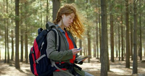 Young Woman Navigating Through Woodland Adventure with Map - Download Free Stock Images Pikwizard.com